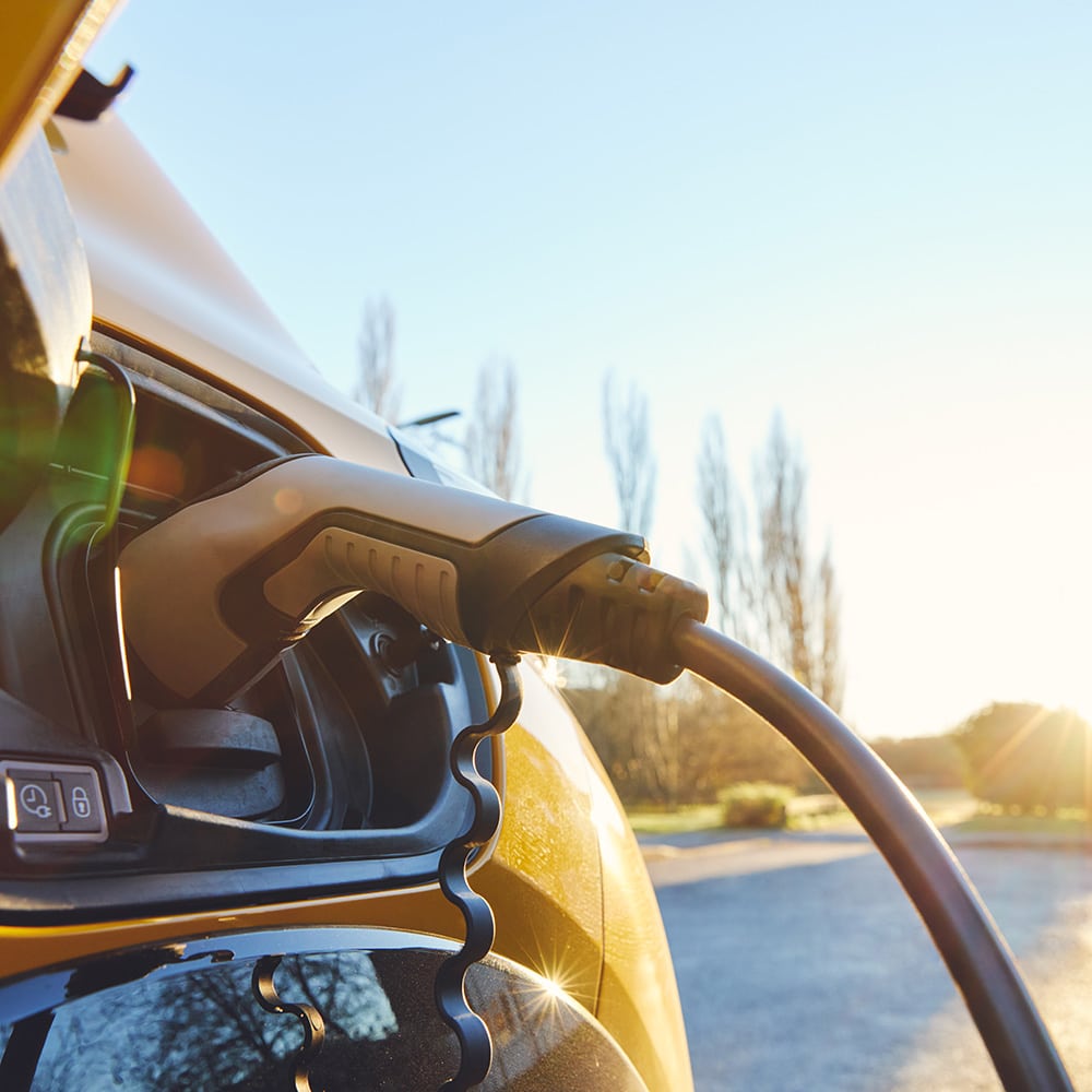 EV home charger plugged in to an electric car.