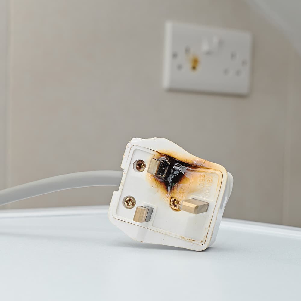 Faulty plug with scorch marks on it.